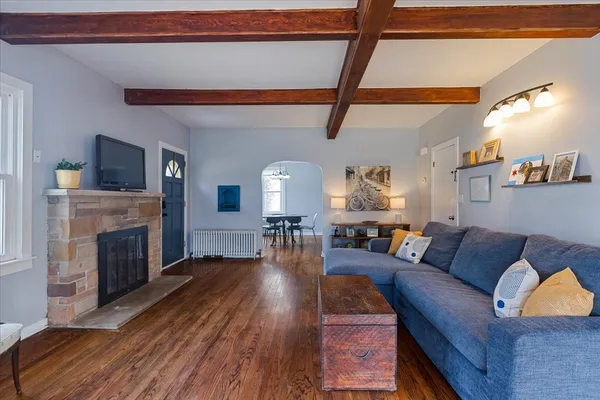 a living room with fireplace furniture and a wooden floor