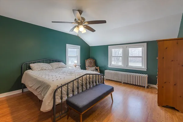 a bedroom with a bed and a window