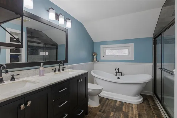 a bathroom with a double vanity sink mirror and toilet