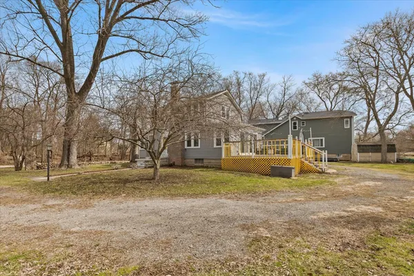 a view of a house with a yard covered in snow