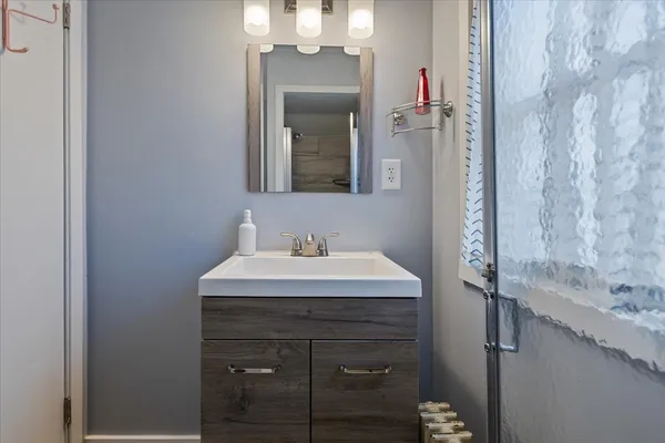 a bathroom with a sink and a mirror