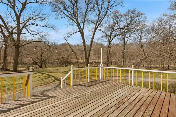 a view of a balcony with wooden floor and fence