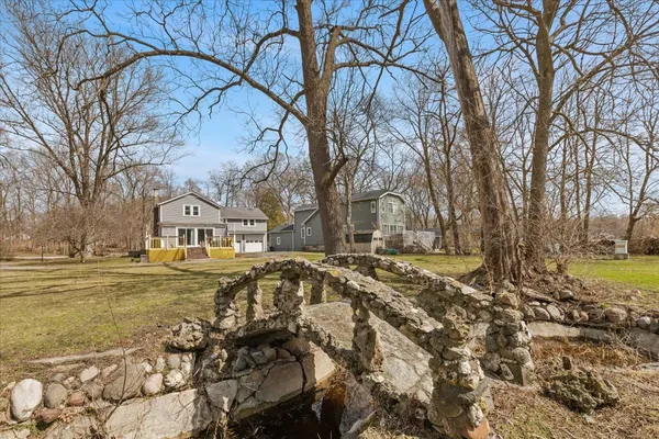 a view of the house with a yard covered with snow