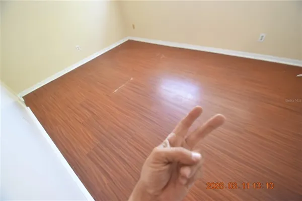 a view of a room with wooden floor