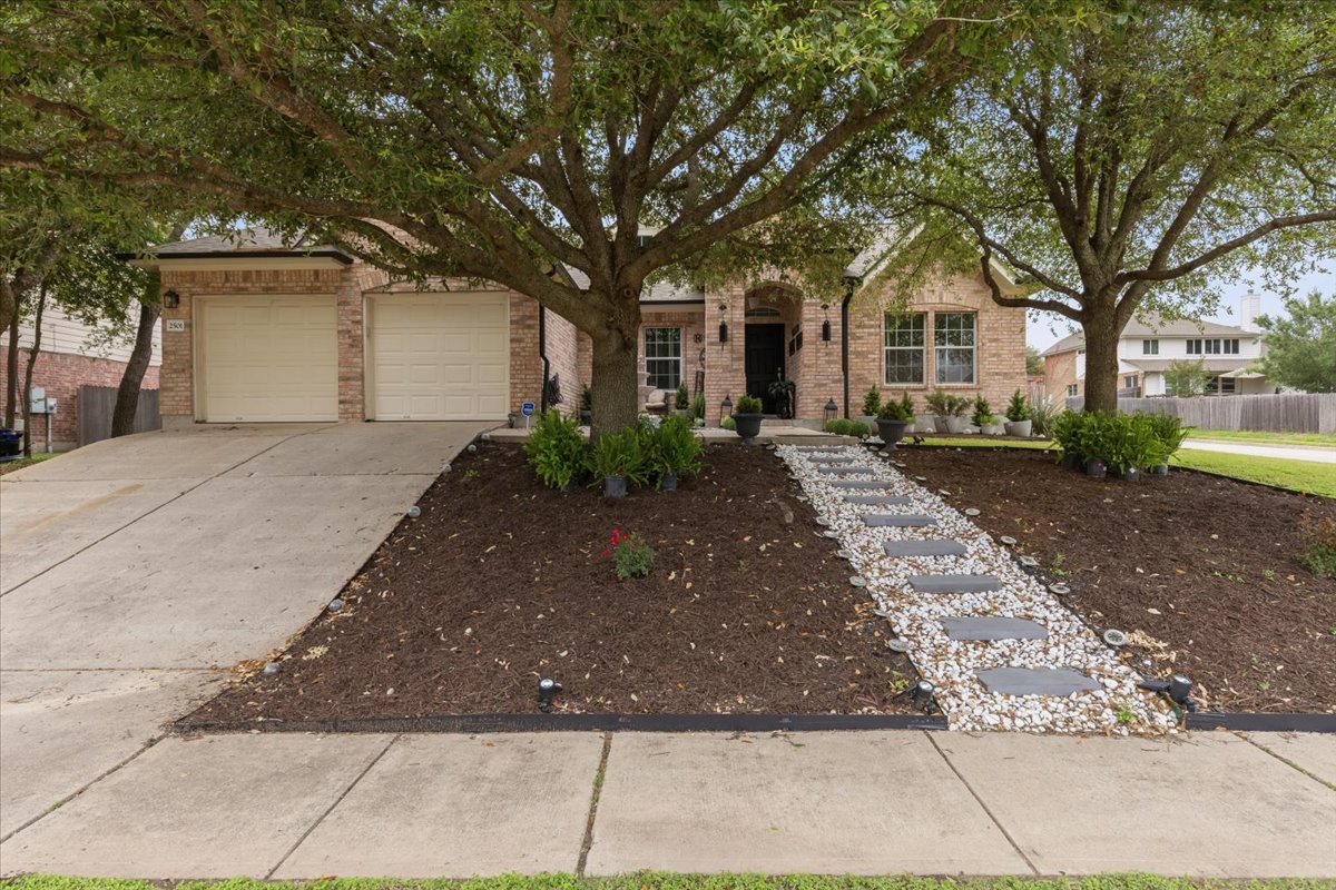 2501 Aspen Meadow Road Leander, TX 78641 - Photo 1 of 30 Traditional brick exterior with an arched entry and two-car garage