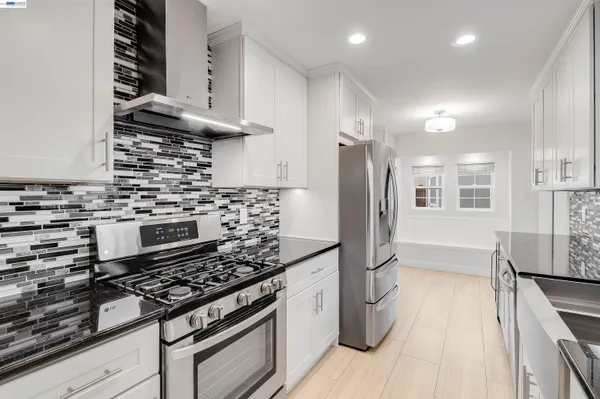 a kitchen with stainless steel appliances granite countertop a stove and a refrigerator