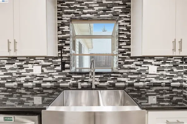 a kitchen with a sink and a stove