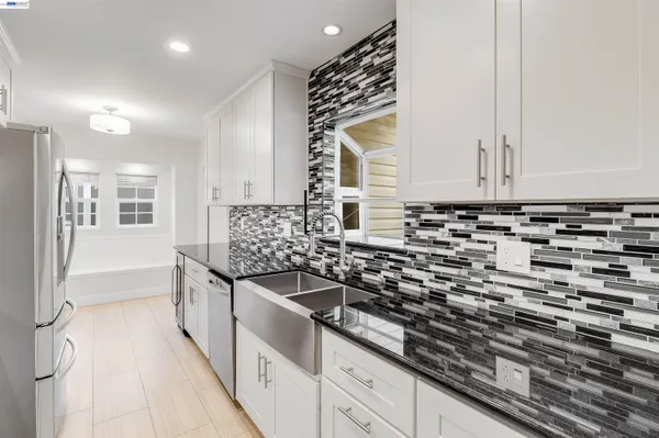 a view of a kitchen with a sink and cabinets