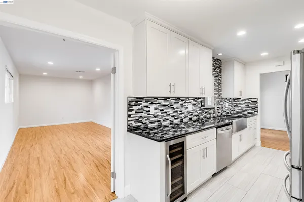a kitchen with stainless steel appliances kitchen island granite countertop a stove and a refrigerator