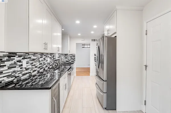 a kitchen with refrigerator and window