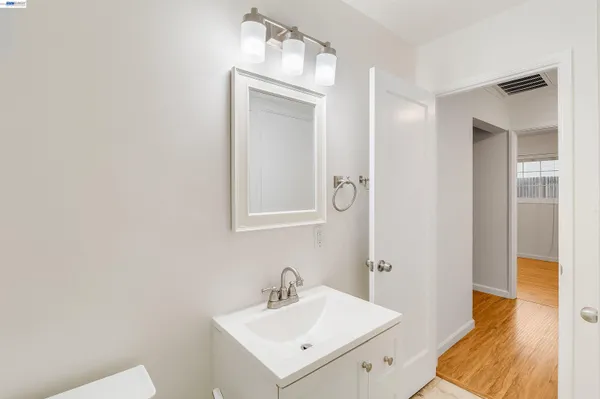 a bathroom with a sink a mirror and a toilet