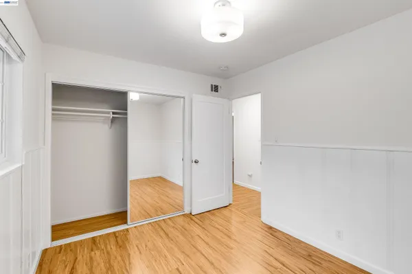 a view of room with wooden floor