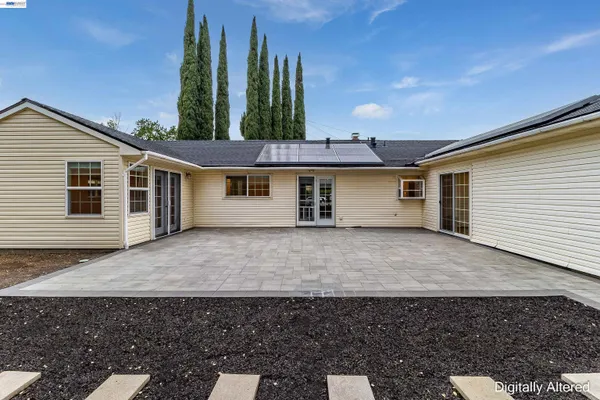 a view of a house with a backyard and trees