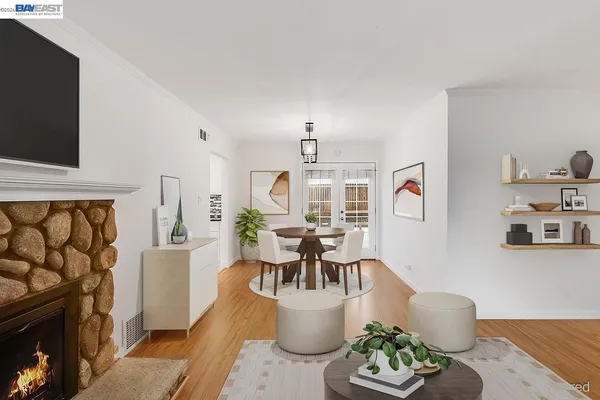 a living room with furniture a flat screen tv and a fireplace