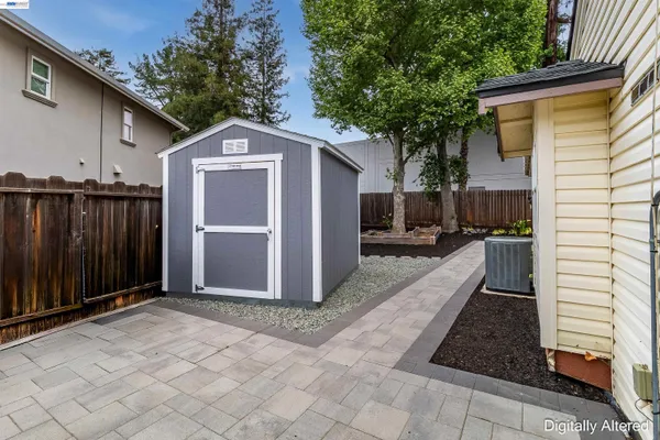 a front view of a house with yard and parking
