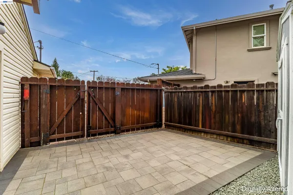 a view of a backyard with wooden fence