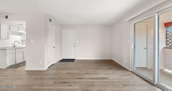 a view of a room with wooden floor and cabinet