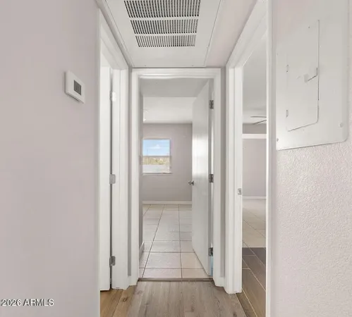 an empty room with white walls and ceiling fan