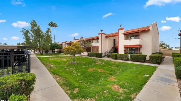 a view of a porch with furniture and a yard