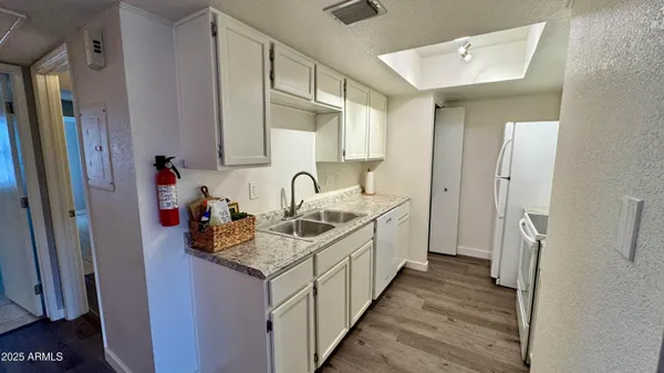 a kitchen with stainless steel appliances white cabinets and a refrigerator