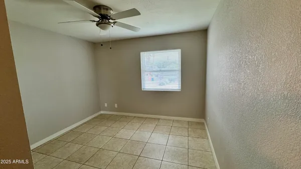 an empty room with windows and closet