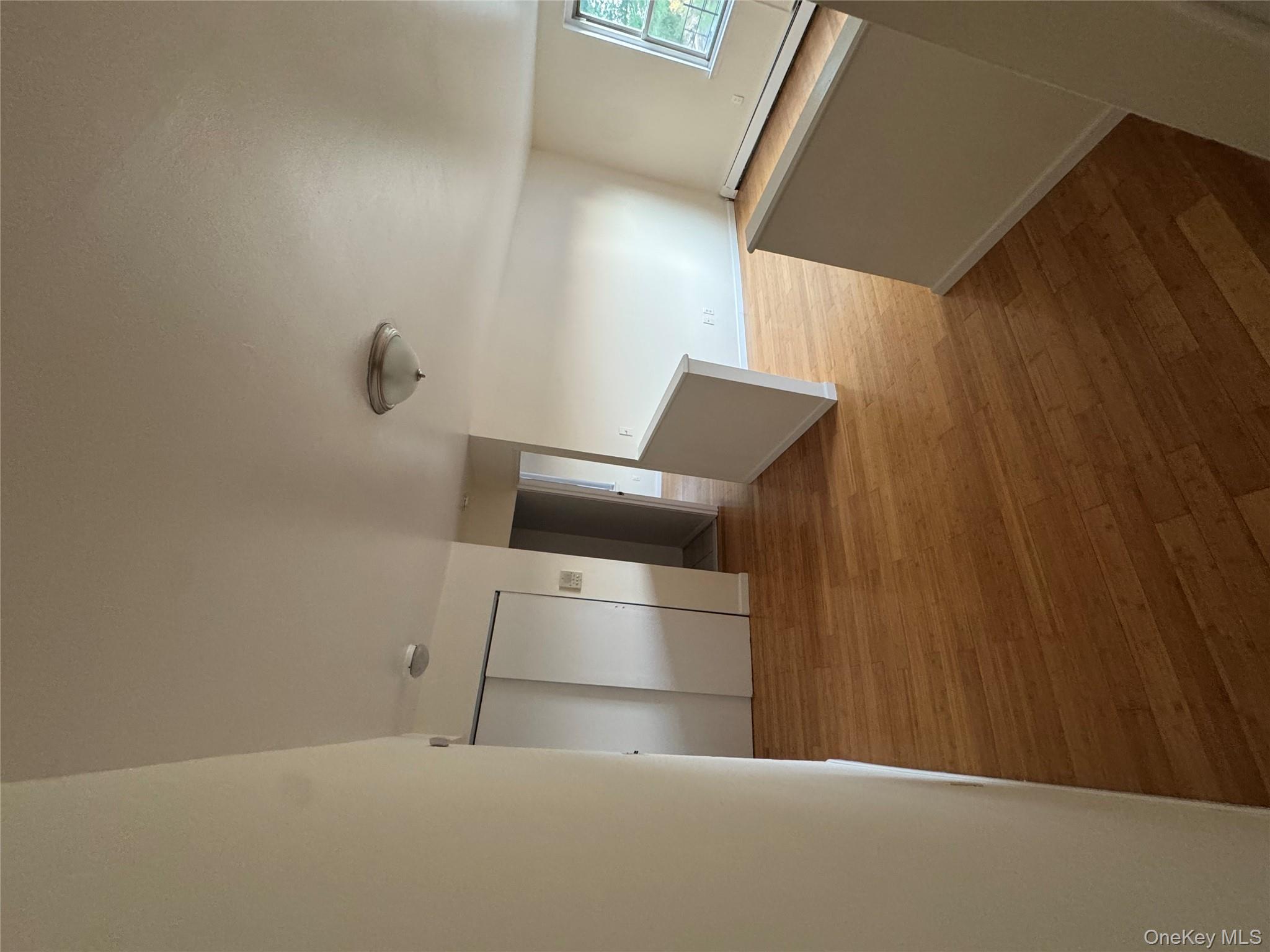 199 Hoover Road, Unit 2F Yonkers, NY 10710 - Photo 4 of 16 Corridor featuring a baseboard heating unit, an upstairs landing, and light wood finished floors