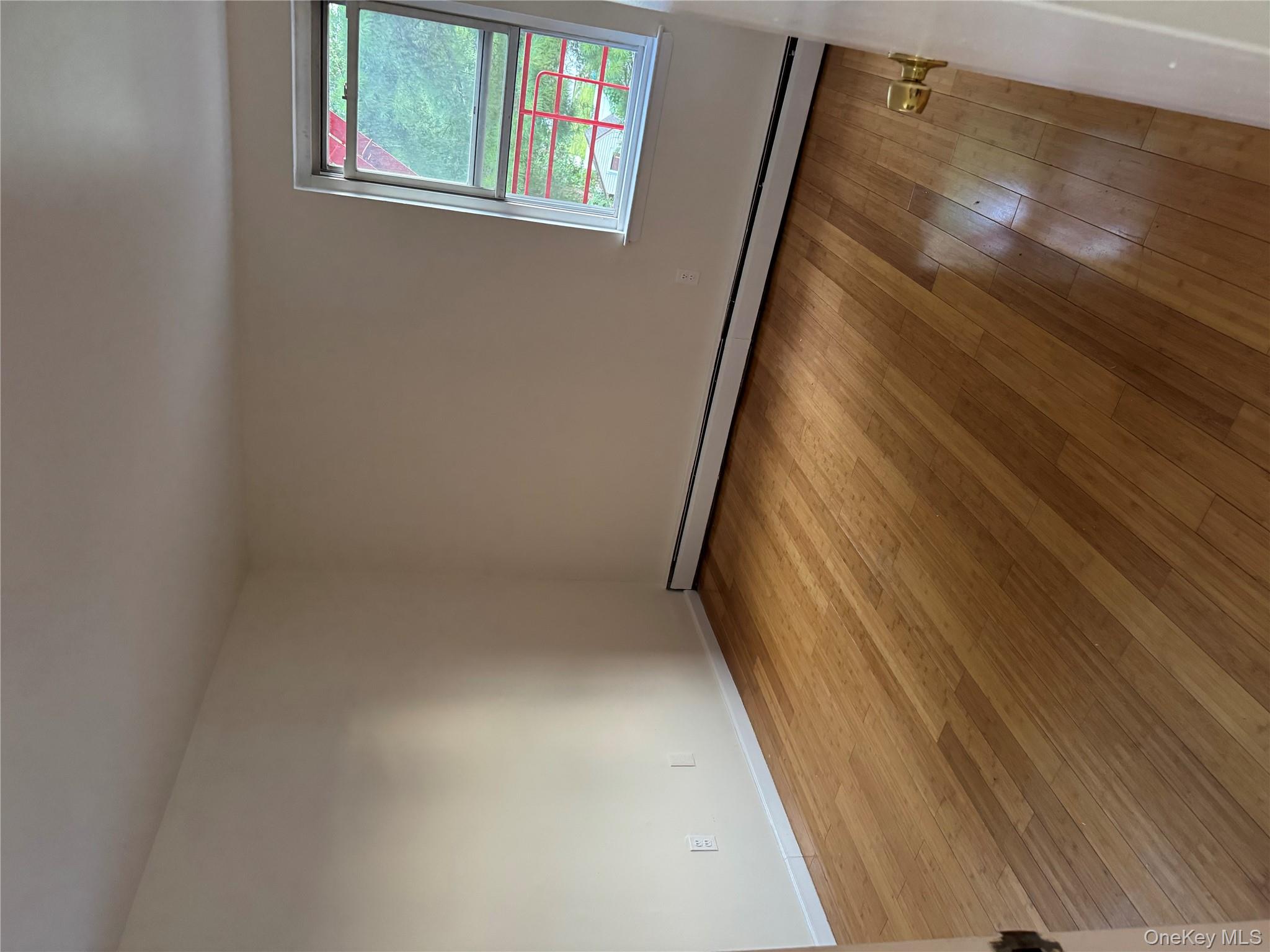 199 Hoover Road, Unit 2F Yonkers, NY 10710 - Photo 7 of 16 Spare room featuring a baseboard radiator and light wood-type flooring