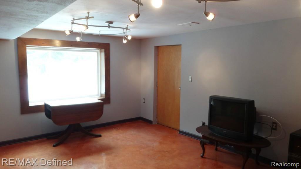 1130 Seneca Road Lake Orion, MI 48362 - Photo 23 of 32 Walk-out basement with large window and custom stained concrete floors