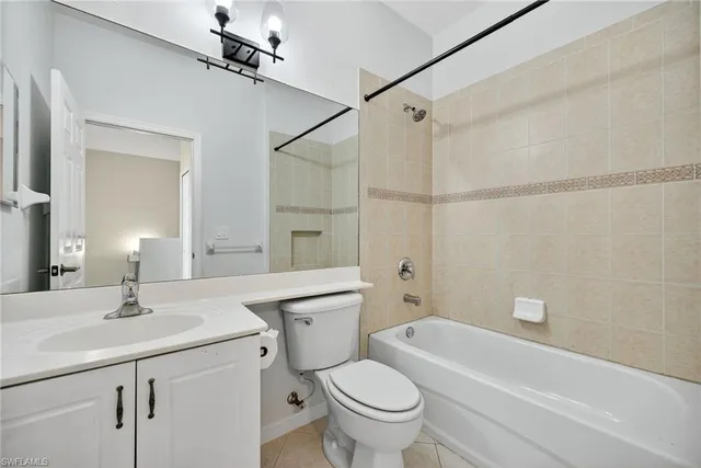a bathroom with a sink toilet vanity and shower