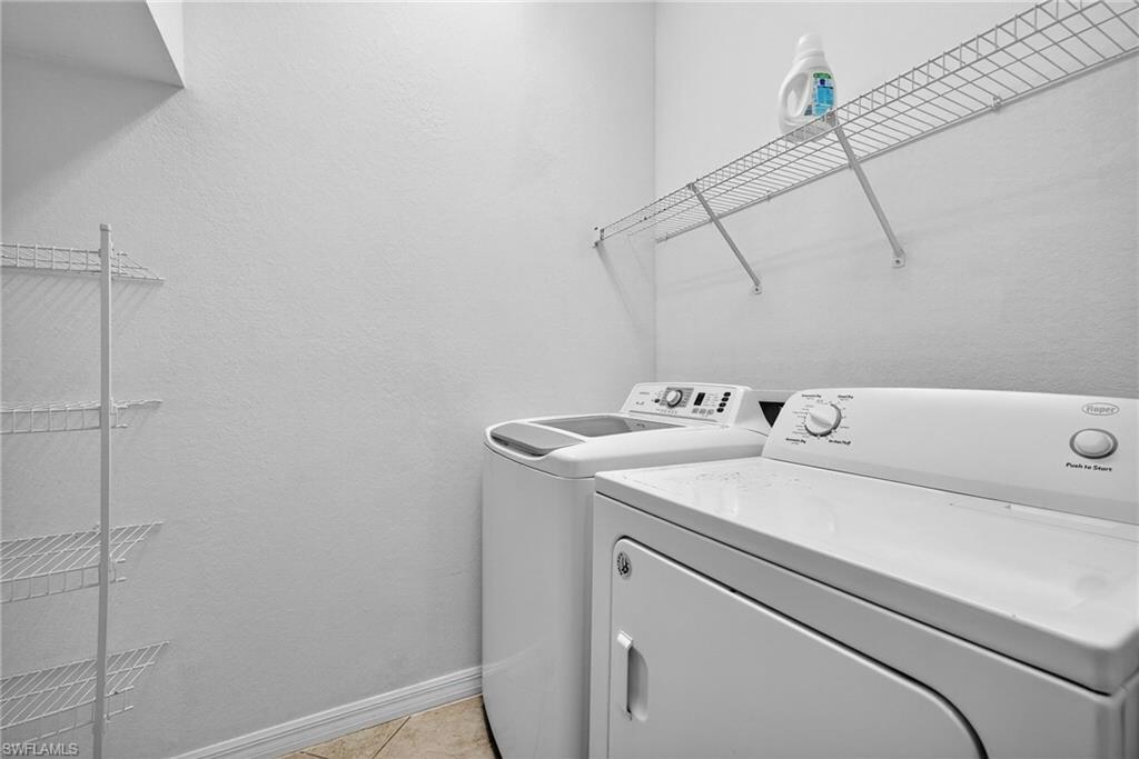 7666 Bristol Circle Naples, FL 34120 - Photo 14 of 19 a utility room with dryer and washer