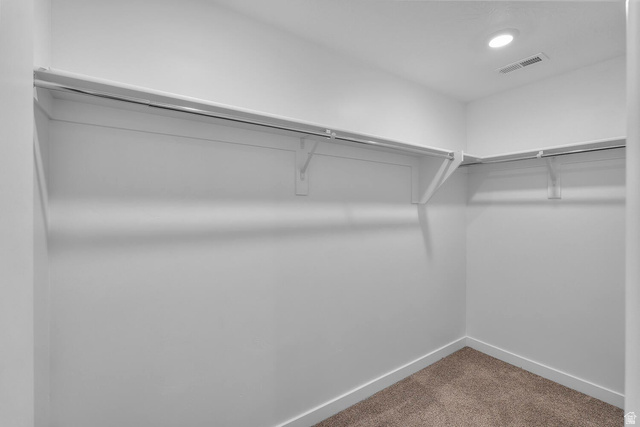 2133 Wolverine Way, Unit 2440 Washington, UT 84780 - Photo 23 of 39 Walk-in closet with white walls, white shelving, metal hanging rods, and recessed lighting