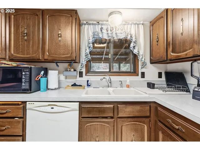 a kitchen with stainless steel appliances granite countertop a sink and cabinets