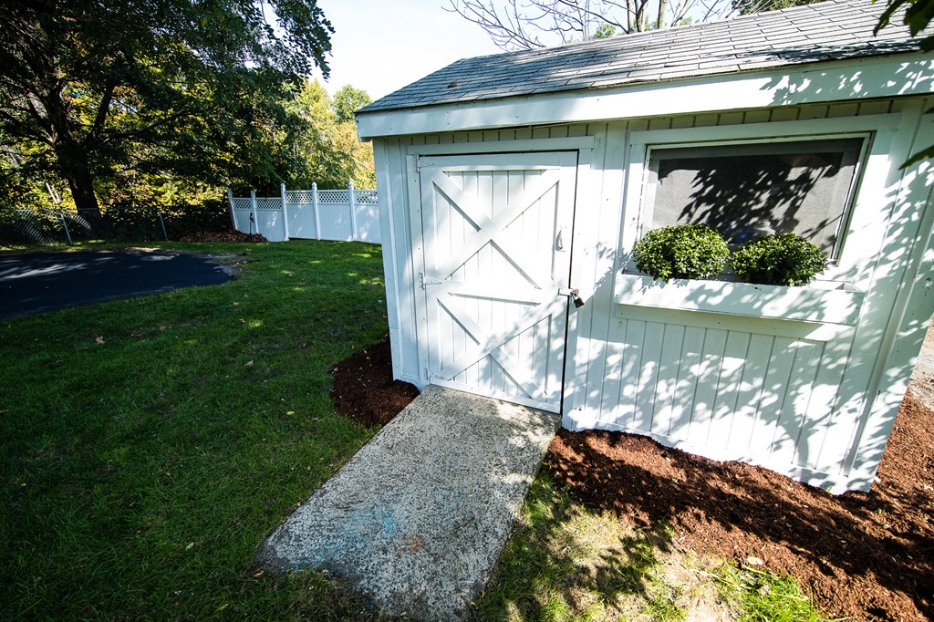 103 North Road Chelmsford, MA 01824 - Photo 8 of 29 a view of a yard with plants and large trees