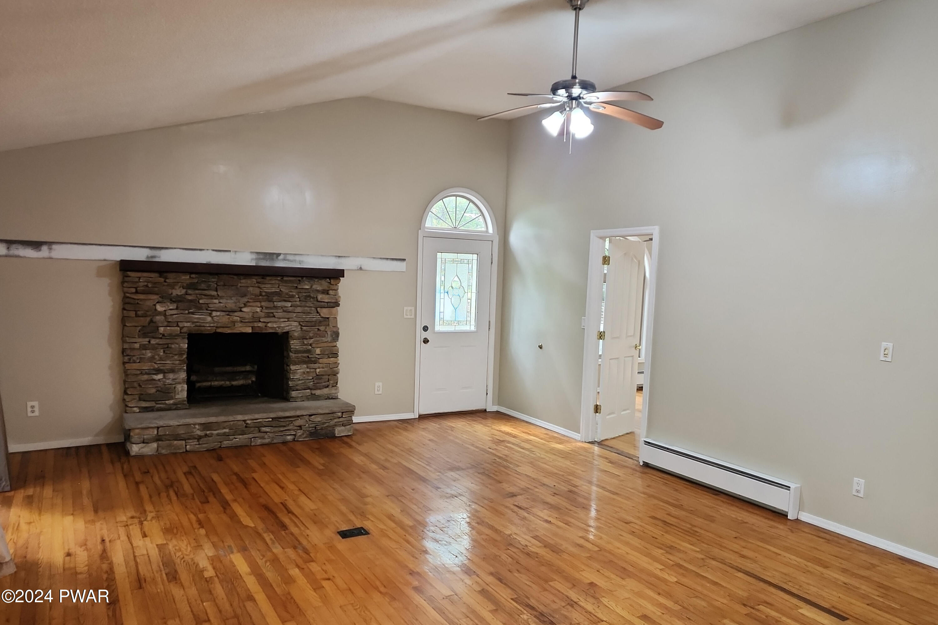 107 Rodeo Lane Hawley, PA 18428 - Photo 6 of 29 a view of a livingroom with a fireplace and wooden floor