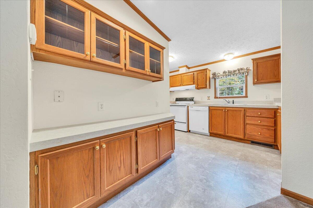 240 Highland Lake Road Union Hall, VA 24176 - Photo 12 of 56 a view of kitchen with stainless steel appliances granite countertop a sink and dishwasher a oven with wooden cabinets