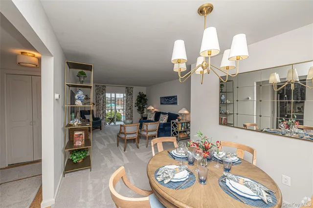 a dining room with wooden floor a glass table and chairs