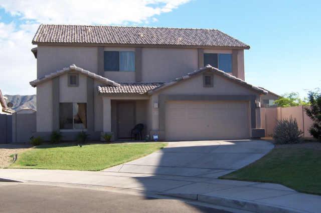 2405 West Carson Road Phoenix, AZ 85041 - Photo 1 of 5 a front view of a house with a yard and garage