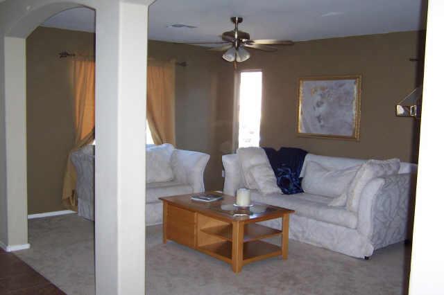2405 West Carson Road Phoenix, AZ 85041 - Photo 2 of 5 a living room with furniture and a chandelier