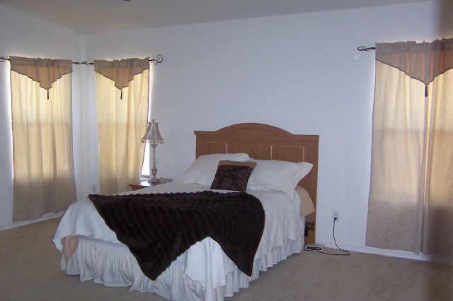 2405 West Carson Road Phoenix, AZ 85041 - Photo 3 of 5 a bedroom with a bed and window