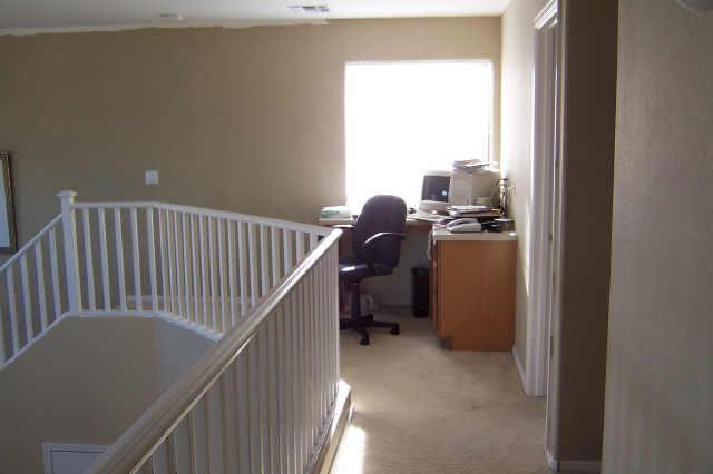 2405 West Carson Road Phoenix, AZ 85041 - Photo 4 of 5 a view of workspace with wooden floor and windows