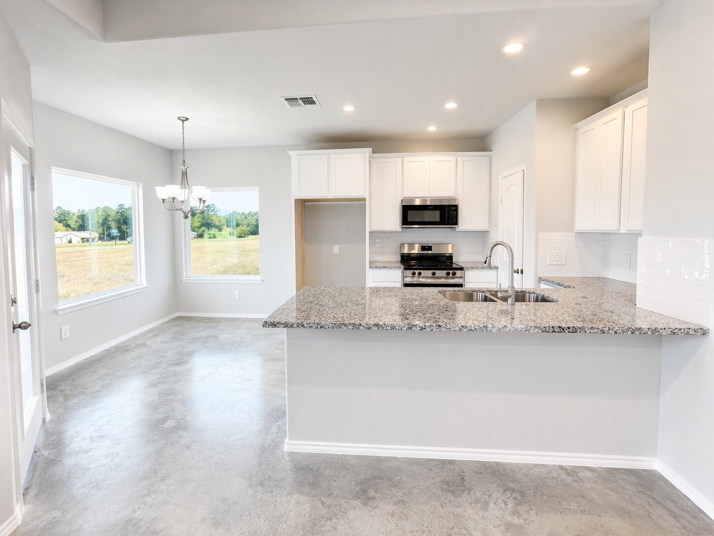 6 Greenway Drive Trinity, TX 75862 - Photo 7 of 27 a kitchen with stainless steel appliances granite countertop a sink a stove a microwave a refrigerator and a granite counter tops