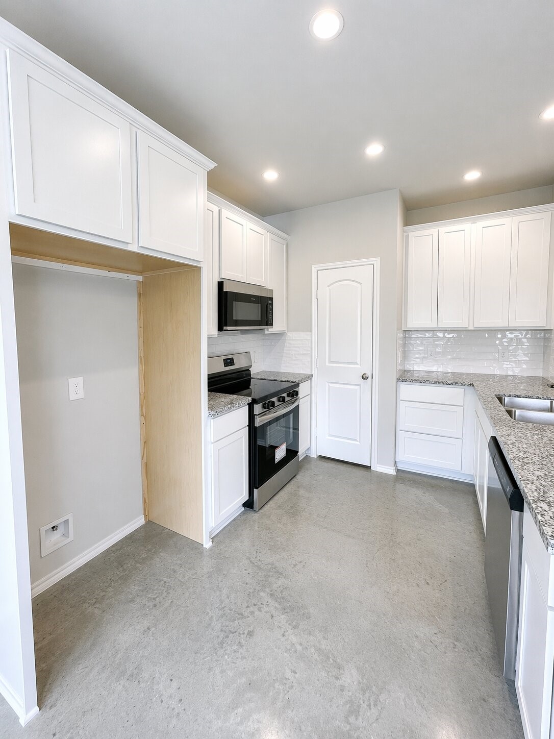 6 Greenway Drive Trinity, TX 75862 - Photo 9 of 27 a kitchen with kitchen island a sink stainless steel appliances and cabinets