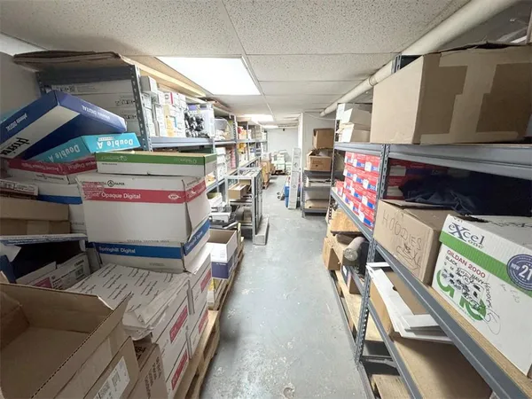 a view of a hallway with workspace and furniture