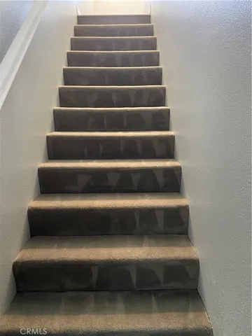 a view of staircase with white walls