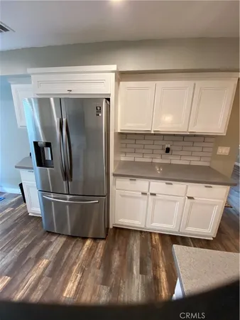a kitchen with kitchen island a counter top space a sink and stainless steel appliances