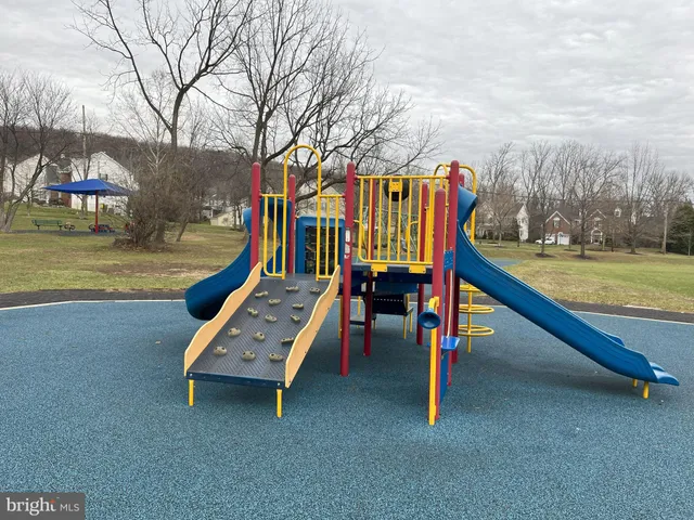 a view of a park with iron fence