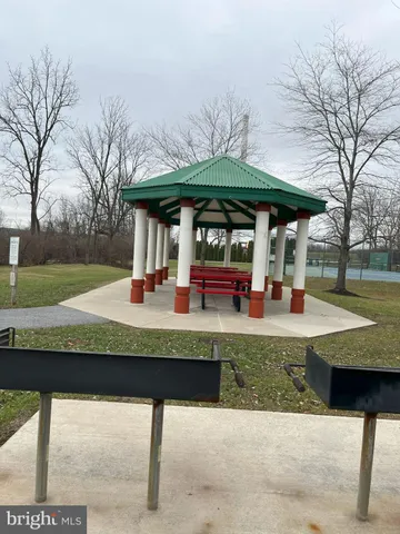 a view of a table and chairs under an umbrella