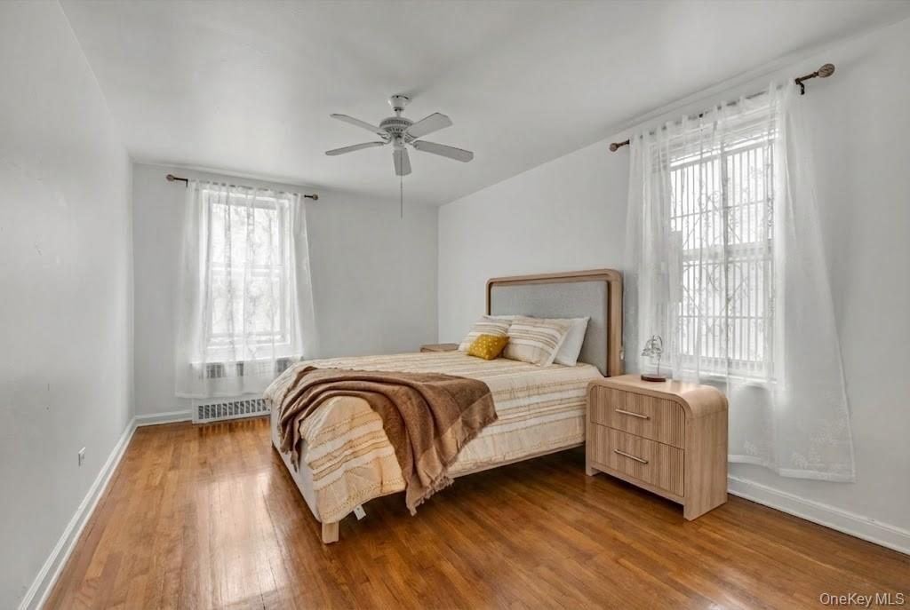 42-25 80th Street, Unit 3D Queens, NY 11373 - Photo 12 of 17 Bedroom featuring wood finished floors and a ceiling fan