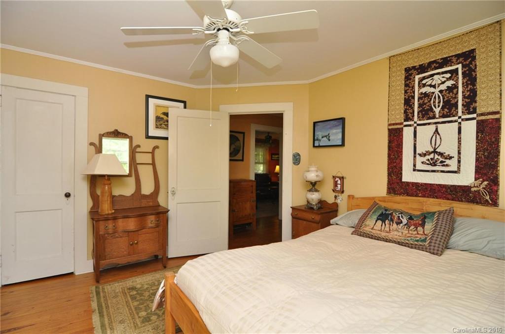 260 W Road Campobello, SC 29322 - Photo 17 of 23 a bedroom with a bed and a chandelier