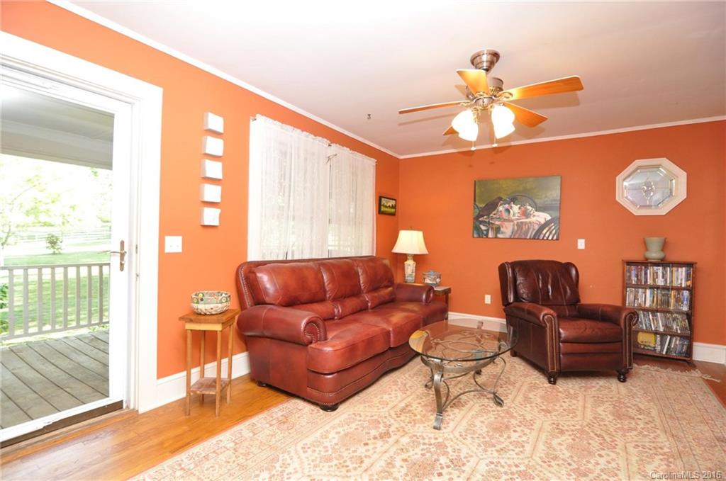 260 W Road Campobello, SC 29322 - Photo 10 of 23 a living room with furniture a fireplace and a large window
